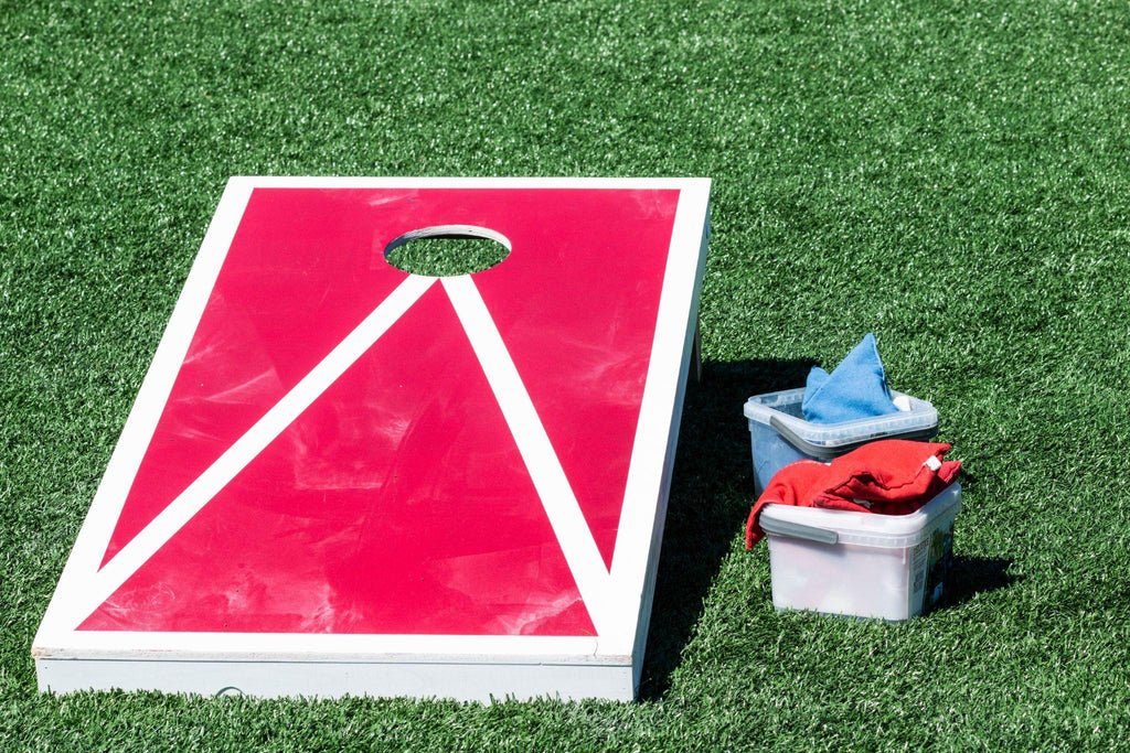 Close up of red and white corn hole game with bean bags