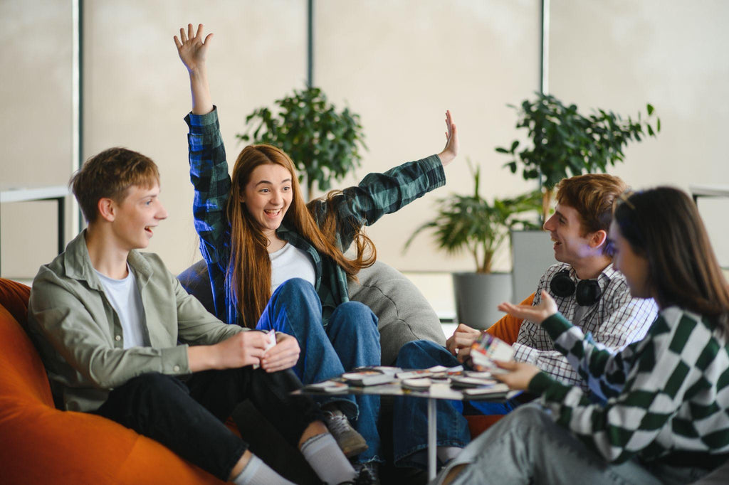 Excited woman winning board game with friends celebrating.