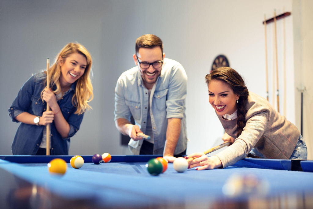 Three coworkers went to cafe after work to play some pool.
