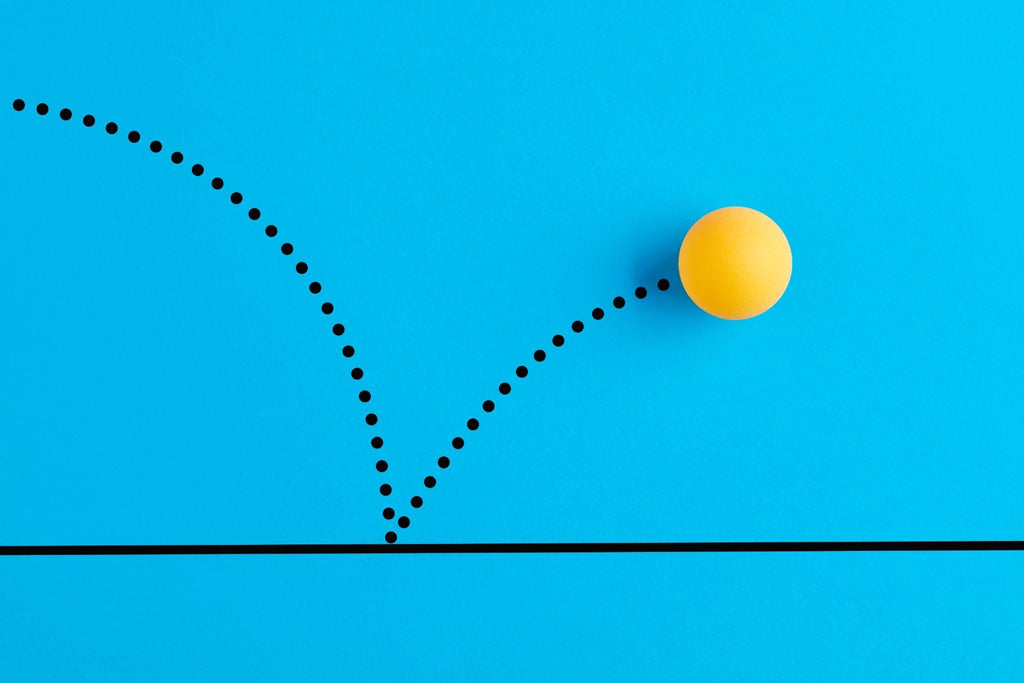 Yellow ping pong ball on blue background bouncing.